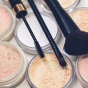 trois pinceaux de maquillage sur des poudres compactes