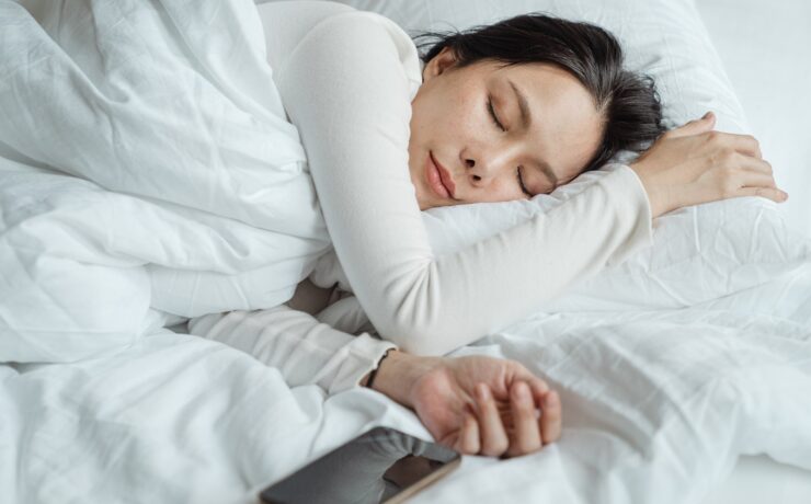 woman sleeping smartphone bed