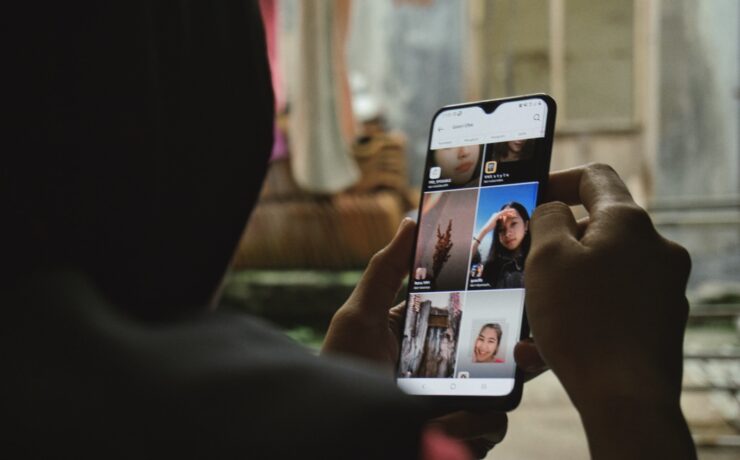 person holding white iphone 5 c scrolling smartphone