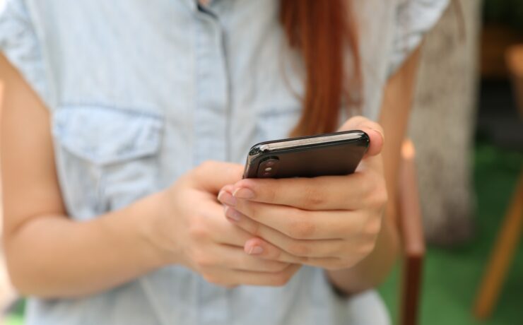 person holding using iPhone X woman smartphone