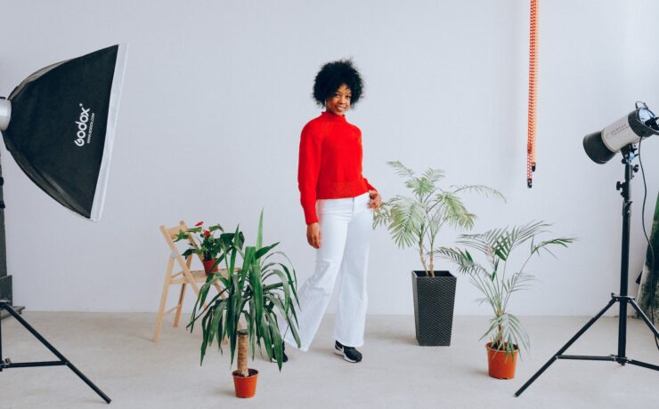 Femme souriante faisant une séance photo avec des plantes